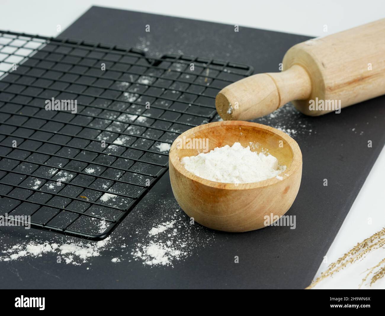 Svuotate il grill in metallo, il laminello, la farina sparsa in un recipiente di legno Foto Stock