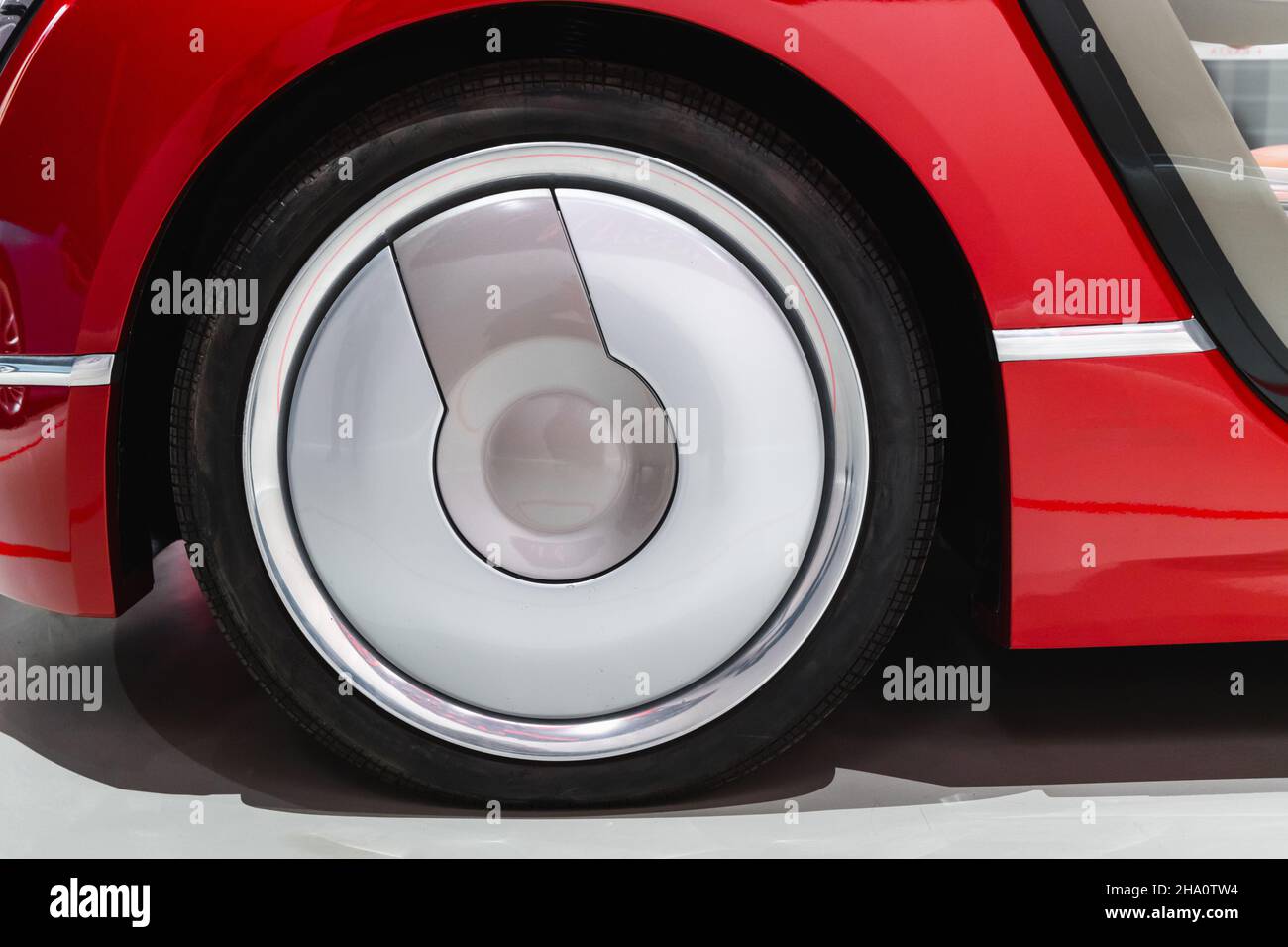 Ruota di una vettura sportiva concettuale rossa, foto da vicino. Elementi di design astratti per auto di lusso moderne Foto Stock