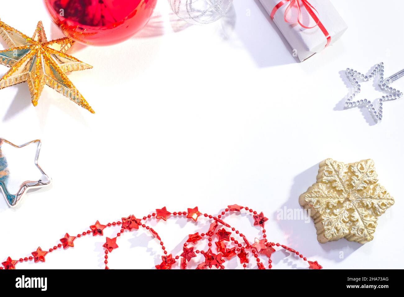 Giocattoli di Natale, candele e decorazioni su sfondo bianco festivo con spazio copia Foto Stock