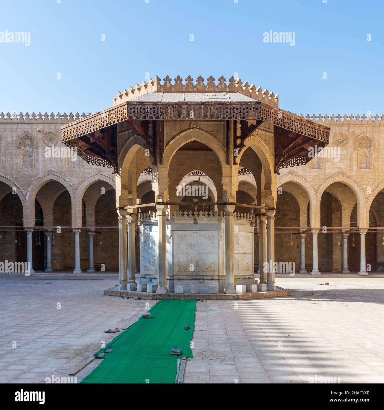 La fontana di abluizione che media il cortile della moschea pubblica storica del Sultan al Muayyad, con sfondo di corridoio ad arco, il Cairo, Egitto Foto Stock