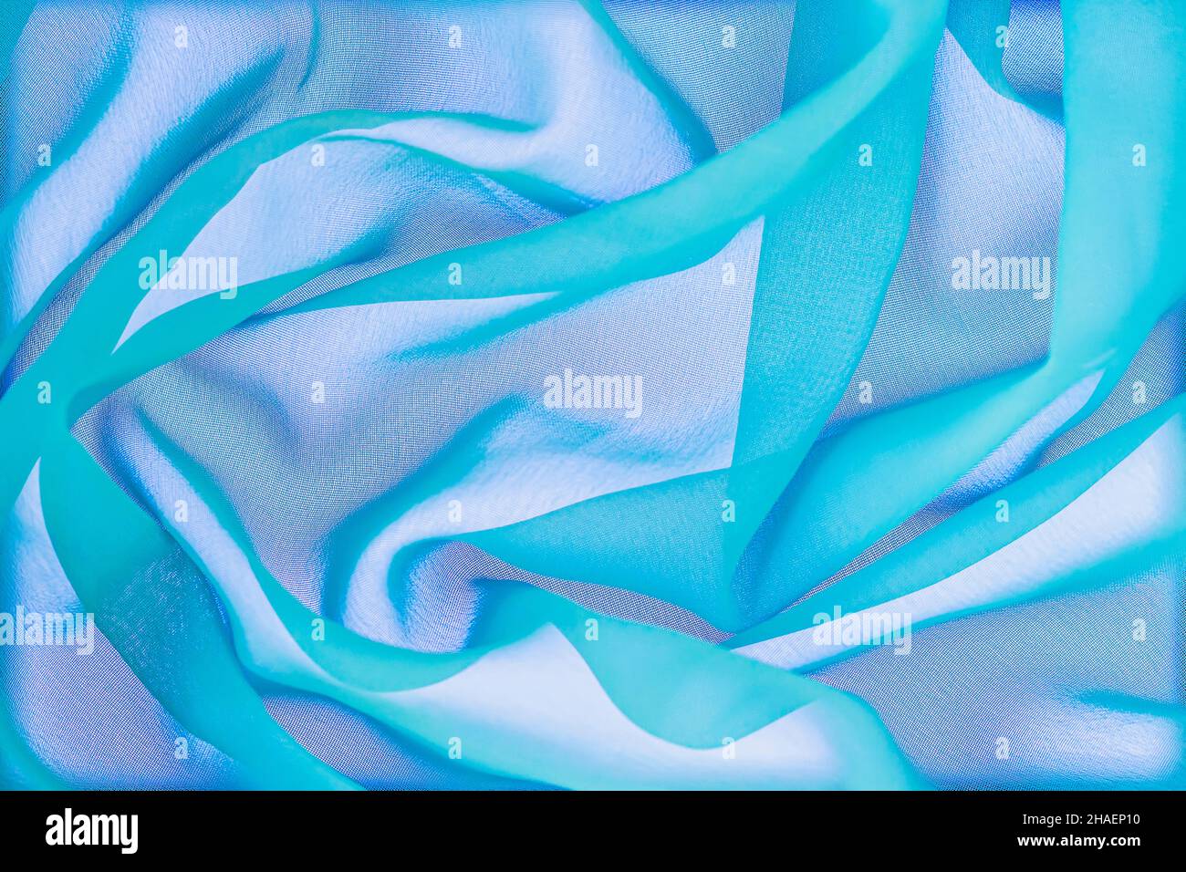 Texture tessile, astratto sfondo colorato multicolore, linee ondulate a spirale, varie sfumature di verde blu trendy Foto Stock