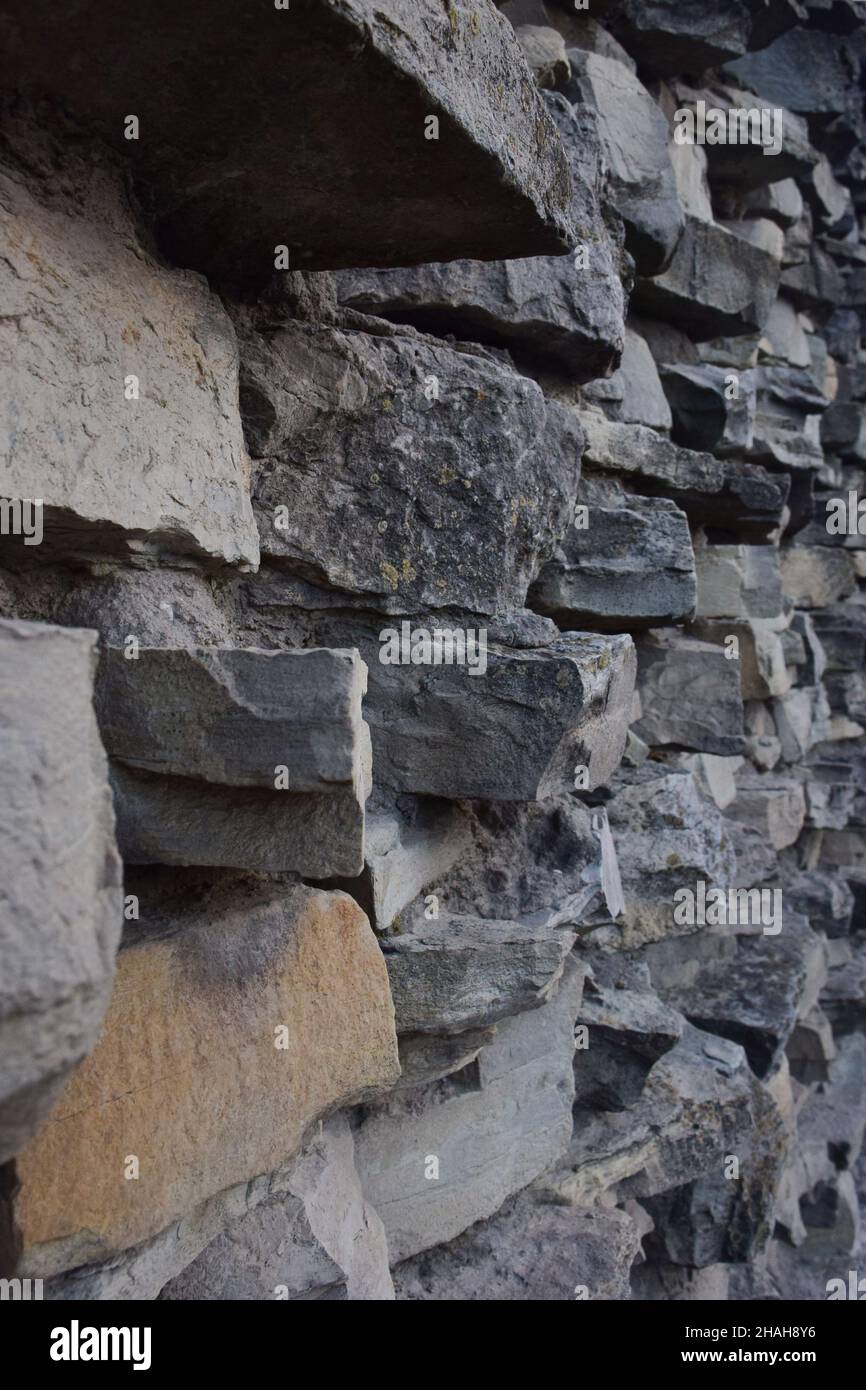La tessitura della pietra, posta sulla parete, di forme e sfumature diverse per l'intera cornice Foto Stock