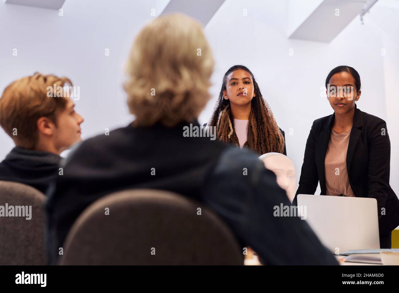 Uomini d'affari che discutono dell'assistente vocale del robot durante la riunione Foto Stock