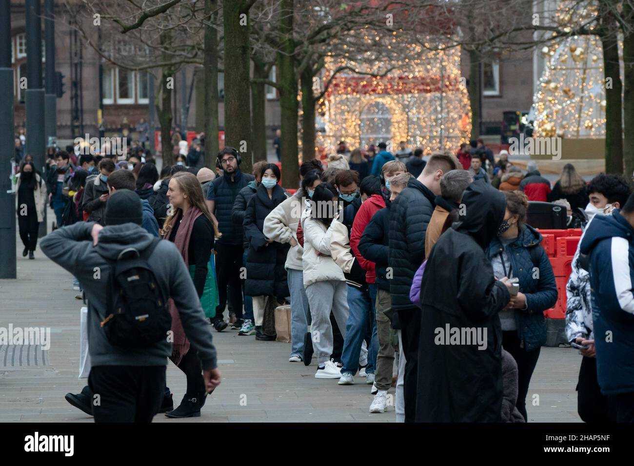 Manchester, Regno Unito, 14th dicembre 2021. I membri del thr pubblico fanno la fila ad un centro di vaccinazione nel centro di Manchester mentre i timori aumentano che la variante di Omicron costringerà il governo a chiudere le parti dell'economia. Credit: Jon Super/Alamy Live News. Foto Stock