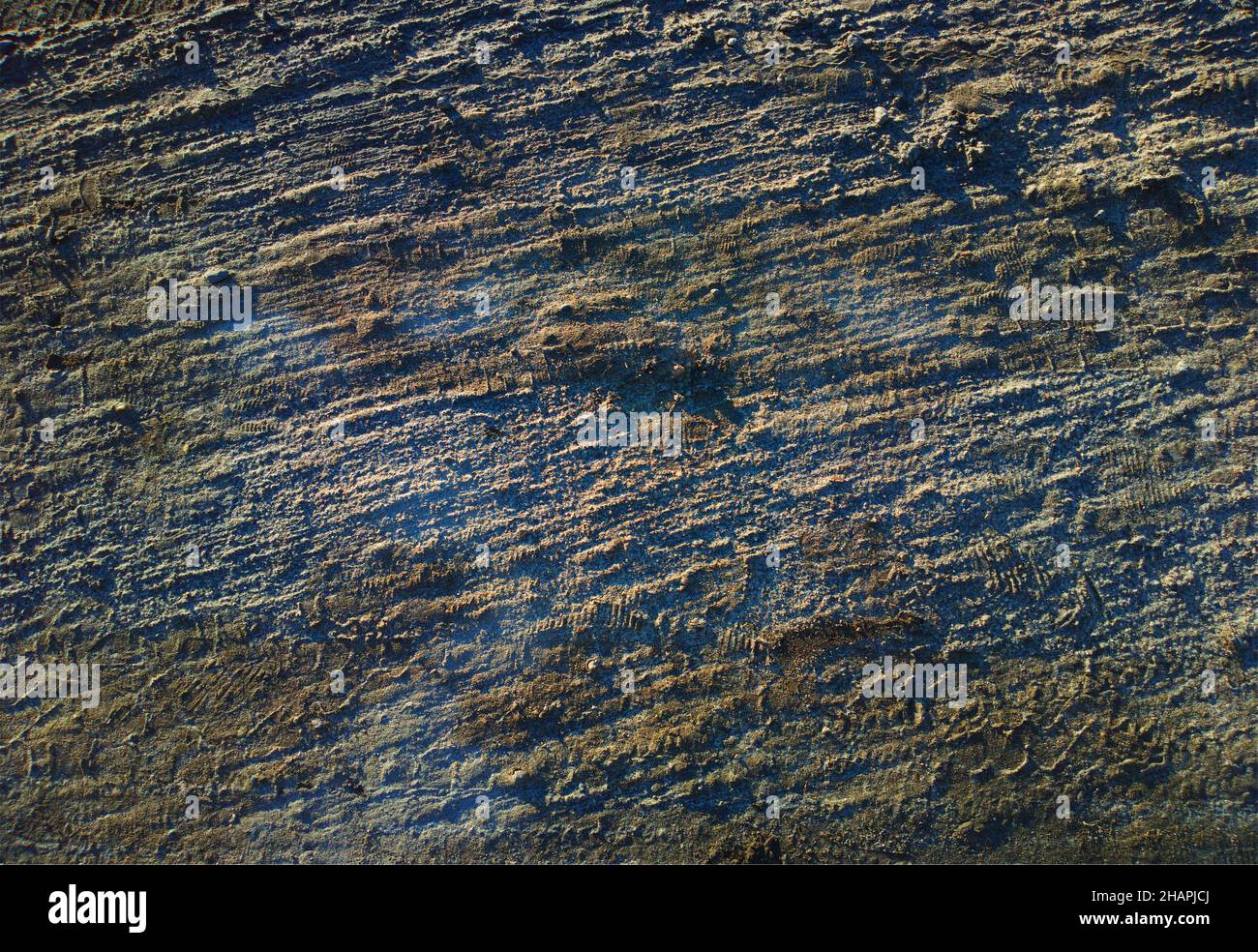 Asfalto accidentato durante il tramonto texture sfondo Foto Stock