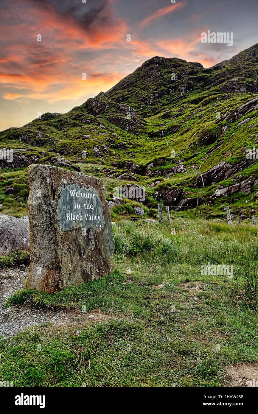 Rock con benvenuto, benvenuto nella Valle Nera, cielo serale, Cummeenduff, MacGillycudys Reeks Mountains, Killarney National Park, Kerry, Irlanda Foto Stock