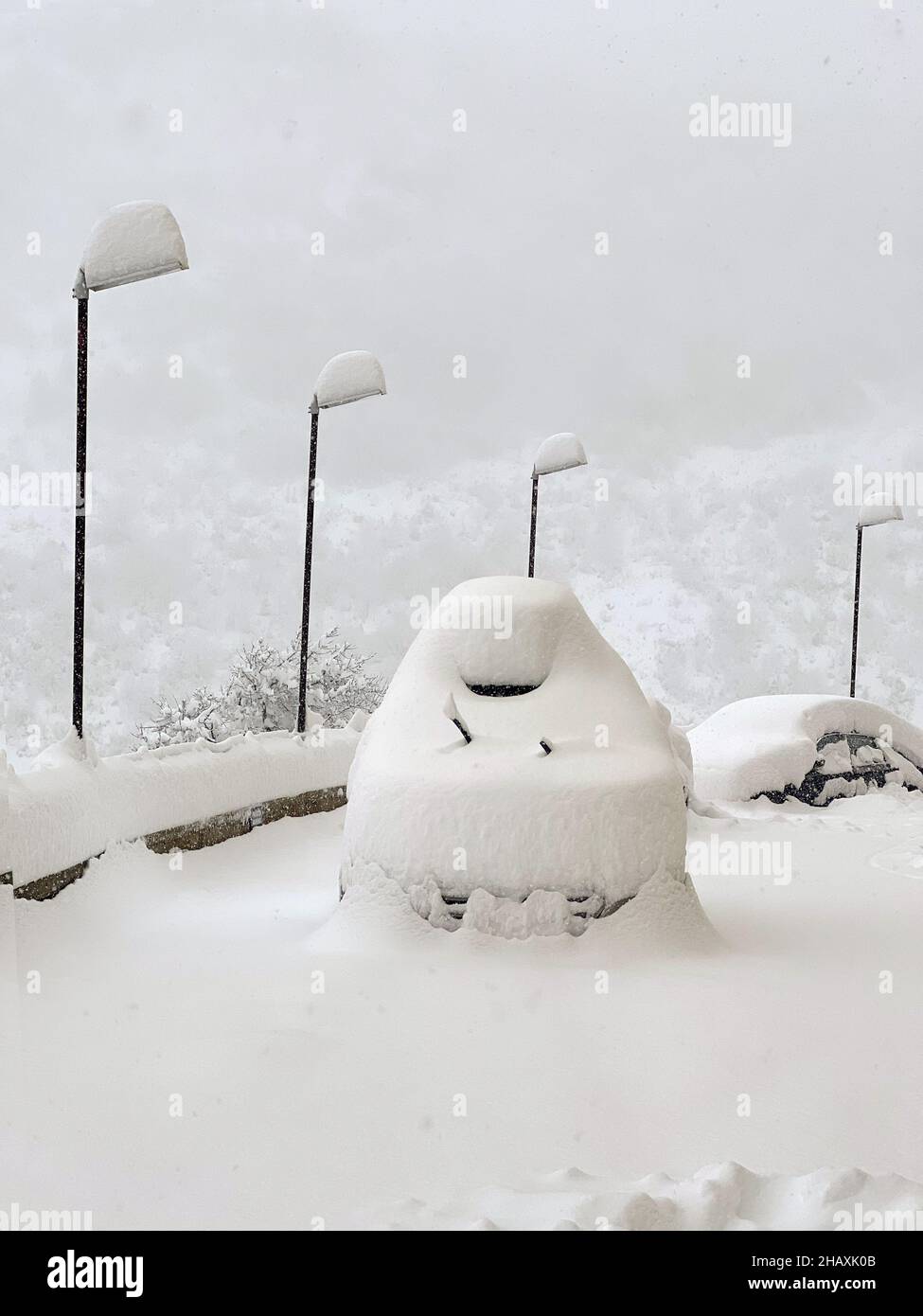 Scatto invernale di un suv coperto di neve su un parcheggio Foto Stock