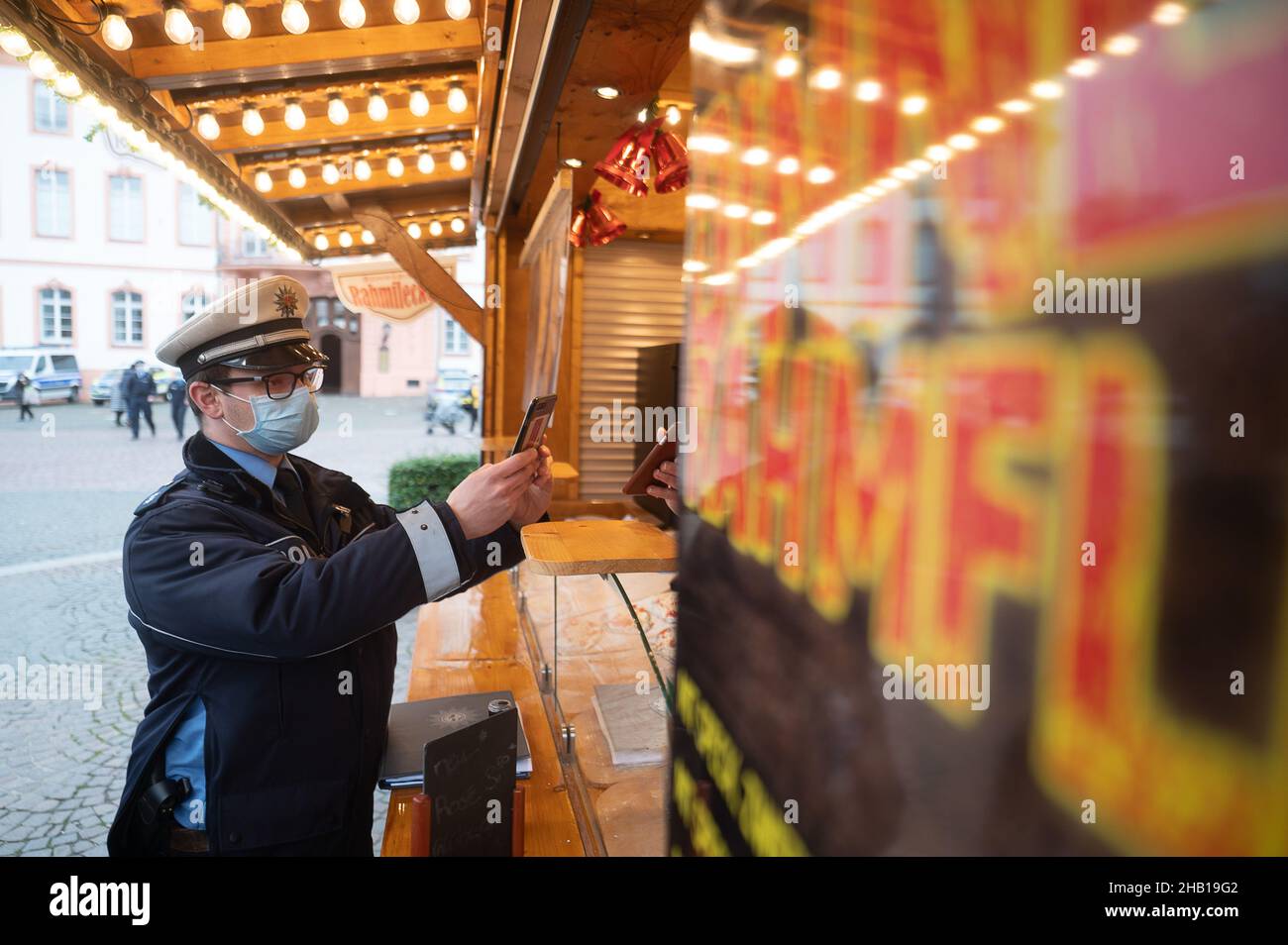 Magonza, Germania. 16th Dic 2021. Un ufficiale di polizia controlla un record di vaccinazione durante un giorno di controllo di conformità nazionale per la pandemia di coronavirus. Credit: Sebastian Gollnow/dpa/Alamy Live News Foto Stock