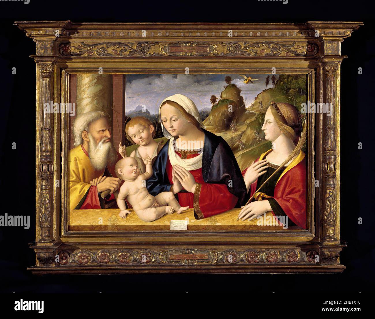 Santa Famiglia con i Santi Giovanni Battista e Caterina d'Alessandria, Marco Palmezzano, Italiano, Scuola di Romagnola, ca. 1459/63-1539, Tempera e olio su pannello di pioppo, Italia, 1521, 23 3/4 x 36 1/4 pollici, 60,3 x 92,1 cm, bambino, bibbia, Caterina d'Alessandria, Cristianesimo, circ 1459/63, europa, Sacra Famiglia, Sacra Famiglia con i Santi Giovanni Battista e Caterina d'Alessandria, artista italiano, pittura italiana, Gesù, Giovanni Battista, Giuseppe, paesaggio, marmorizzato, Marco Palmezzano, Marco Mamezzano, Maria, nuovo testamento, palma, pioppo, Religione, rinascita, santi, Santi Giovanni Battista Foto Stock
