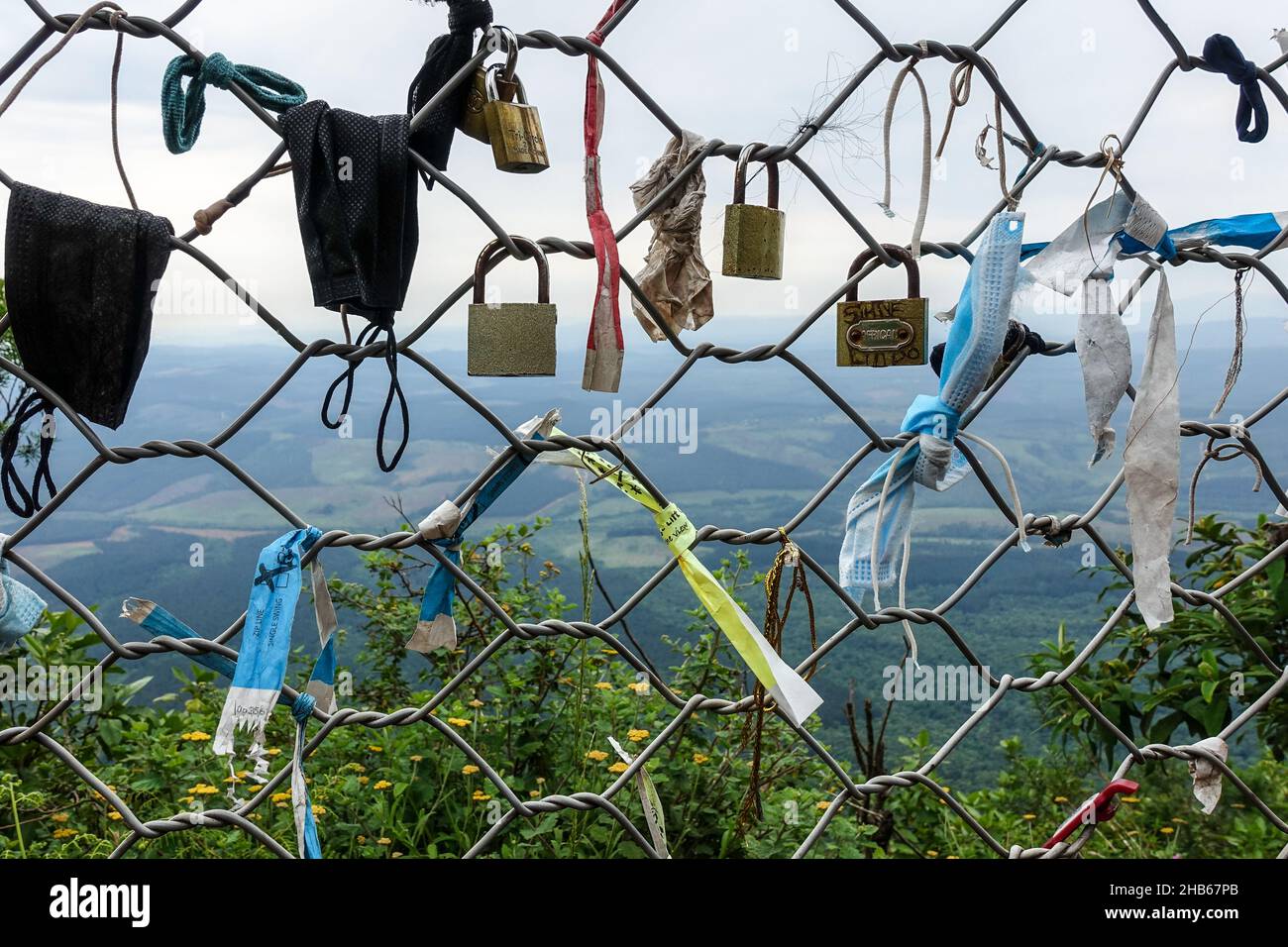 Viaggiando durante la pandemia del COVID19: Serrature e maschere facciali sulla recinzione al punto di vista della finestra di Dio lungo il percorso panoramico, Sudafrica Foto Stock