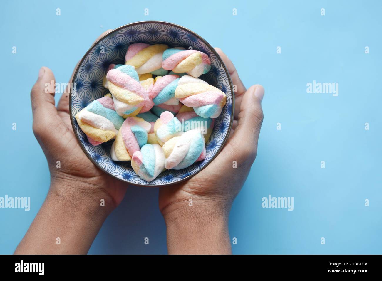 caramelle marshmallow in una ciotola su blu Foto stock - Alamy