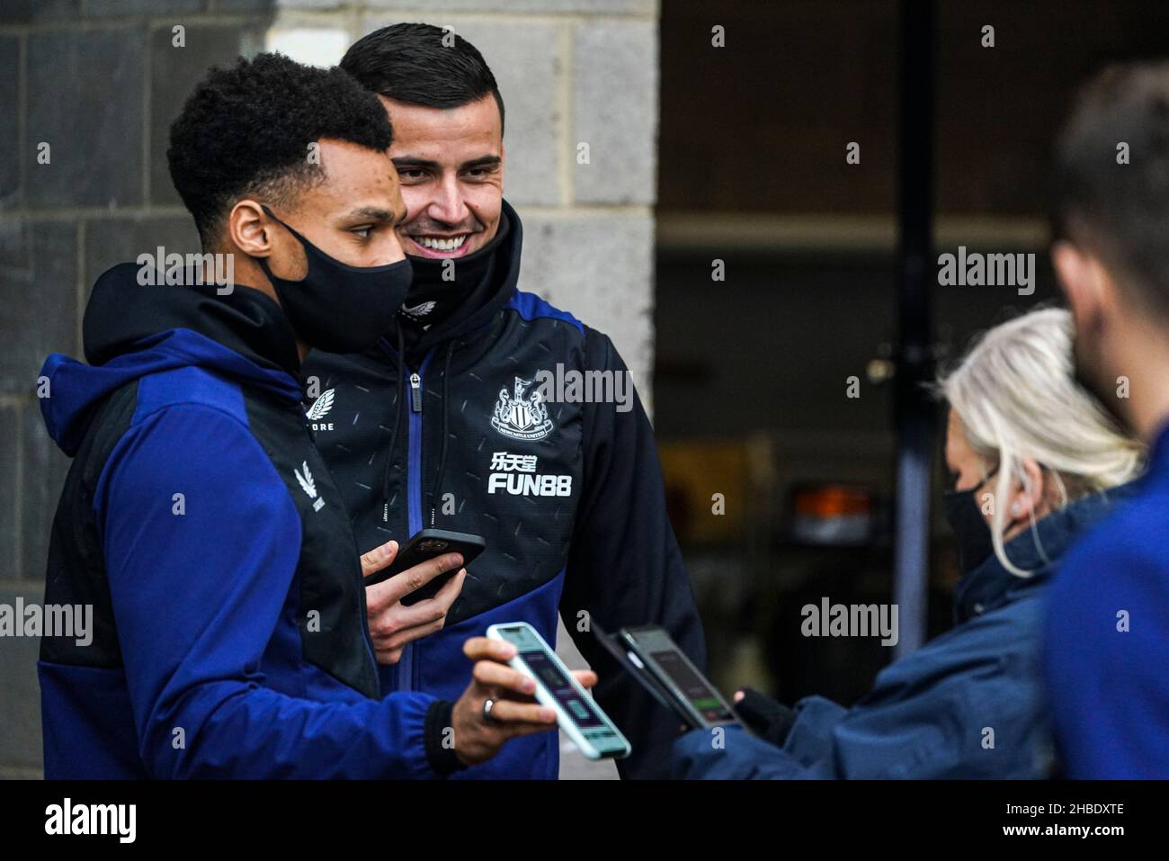 *NOTA EDITORIALI: Questa immagine è stata pixelata per garantire che il codice QR non sia visibile*. Jacob Murphy (a sinistra) e Karl Darlow (a destra), portiere del Newcastle United, mostrano i loro passi all'arrivo prima della partita della Premier League al St. James' Park, Newcastle. Data foto: Domenica 19 dicembre 2021. Foto Stock