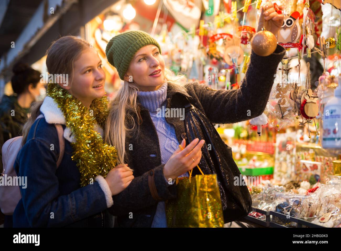 Madre e figlia adolescente che sceglie l'albero di Natale alla fiera di Natale Foto Stock