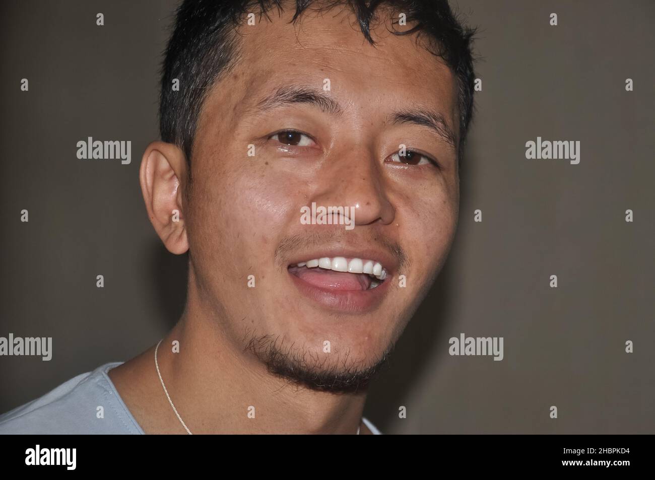 Primo piano di un volto asiatico con lo sguardo alla fotocamera Foto Stock