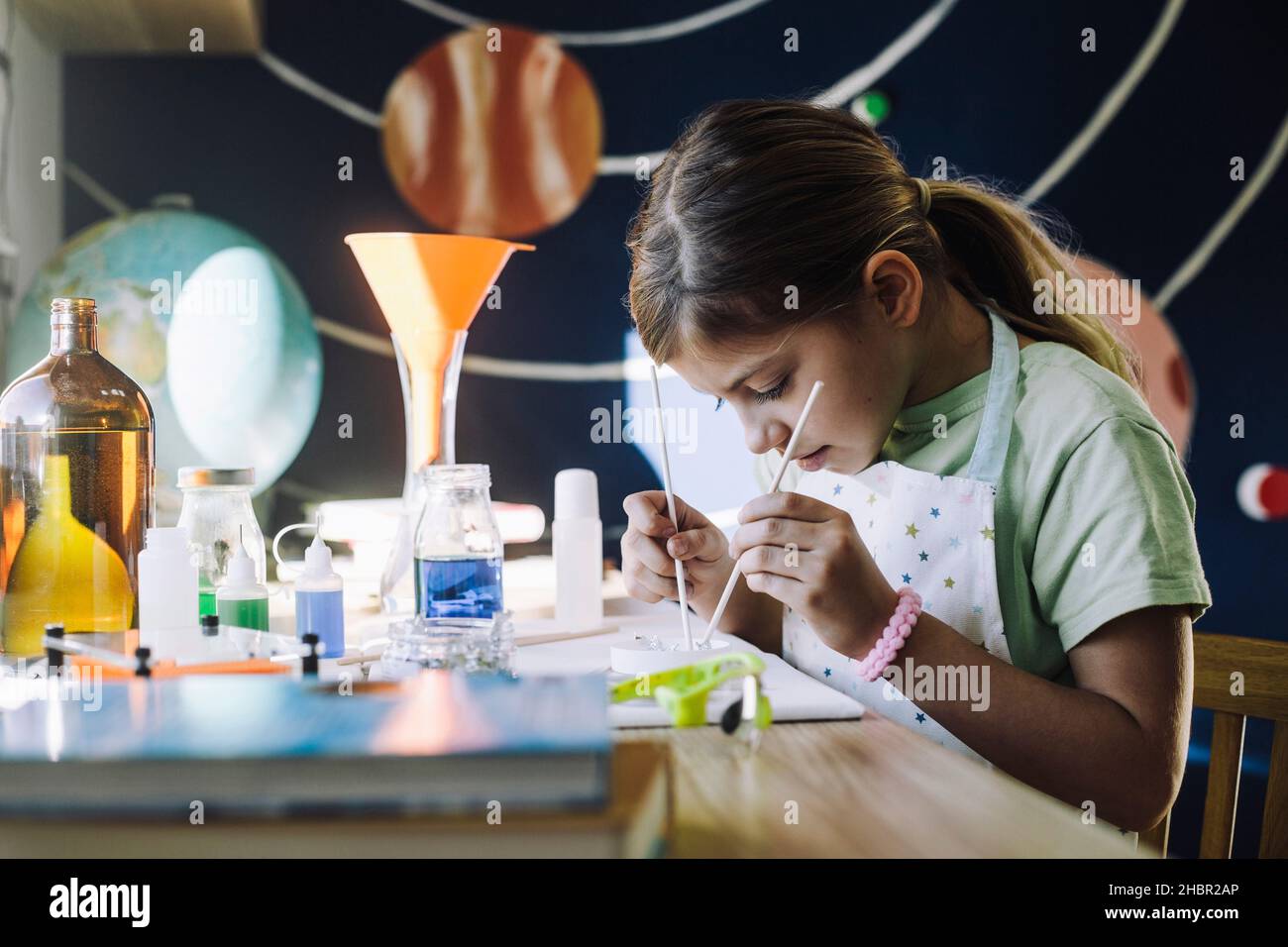 Ambiziosa studentessa studentessa che impara l'esperimento scientifico a casa Foto Stock