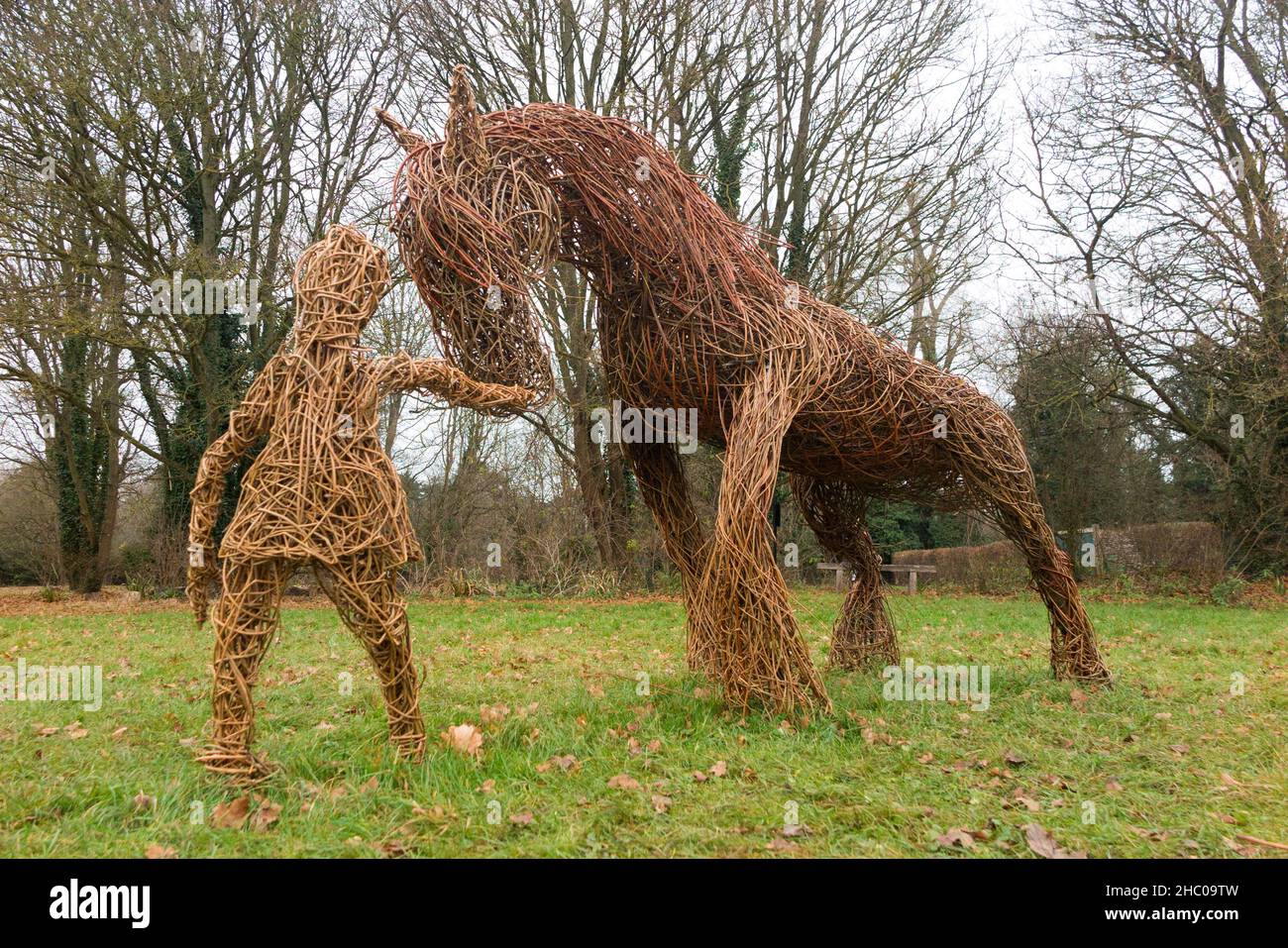 Scultura di persone antiche modellato da rami di Willow durante il periodo del raccolto e con il cavallo Shire e attrezzi scythe, in mostra a Runnymede, Surrey. REGNO UNITO. Runnymede fu il luogo della firma della Magna carta nel 1215. (127) Foto Stock