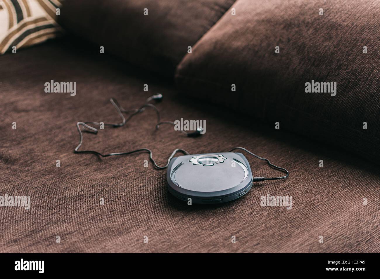 Lettore cd portatile noto come discman appoggiato sul divano a casa Foto Stock