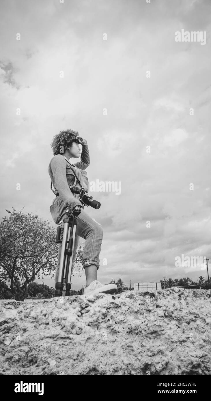 Ragazza che è dedicata alla fotografia si prepara da casa per andare a scattare foto di Foto Stock