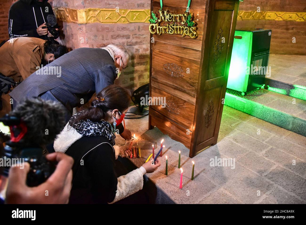 Srinagar, India. 25th Dic 2021. I devoti cristiani illuminano le candele all'interno della chiesa di San Lukes il giorno di Natale a Srinagar.dopo tre decenni, la chiesa di San Luca di 125 anni, rimasta desolata a seguito della crescente violenza nel 1990s, è stata rinnovata e aperta per i fedeli il Natale. I cristiani in India e in tutto il mondo celebrano il Natale per commemorare la nascita di Gesù, figura centrale del cristianesimo. Credit: SOPA Images Limited/Alamy Live News Foto Stock