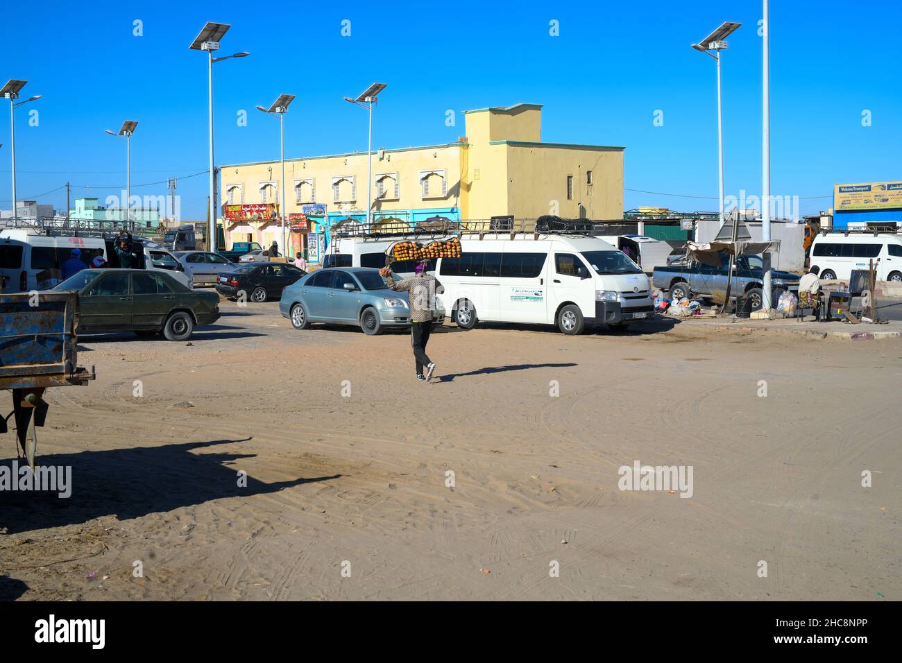 Uomo che porta sulla testa in una strada a Nouakchott Foto Stock