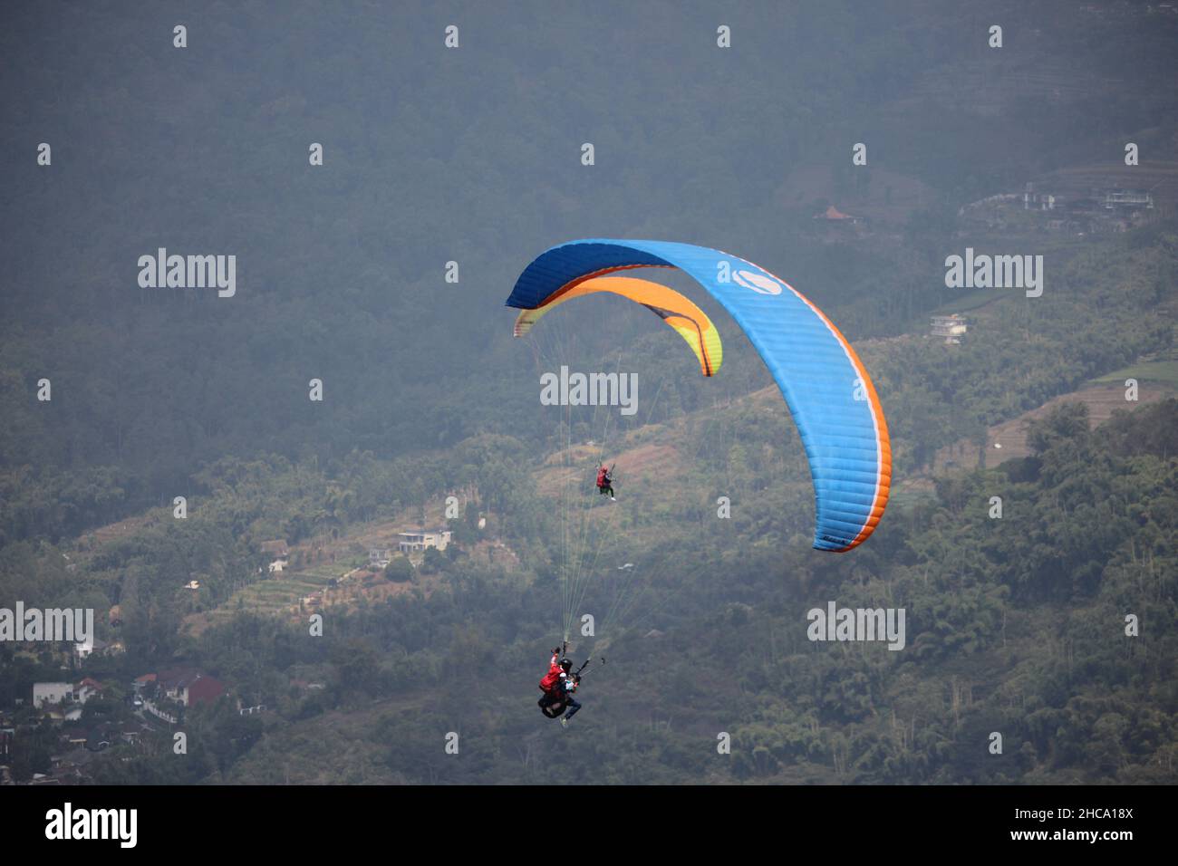 Parapendio sport che si svolge ogni settimana se il tempo è favorevole, che è su una delle montagne in Giava orientale, Indonesia Foto Stock