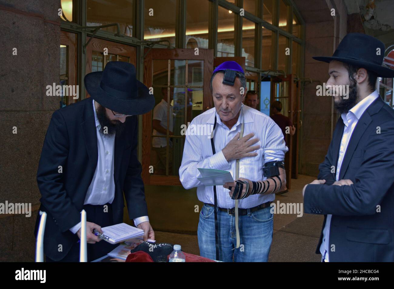 Ragazzi ebrei ortodossi di Chabad che si rivolgono e esortano gli ebrei a pregare indossando tefillin. Alla Grand Central Station di Manhattan, N. Foto Stock