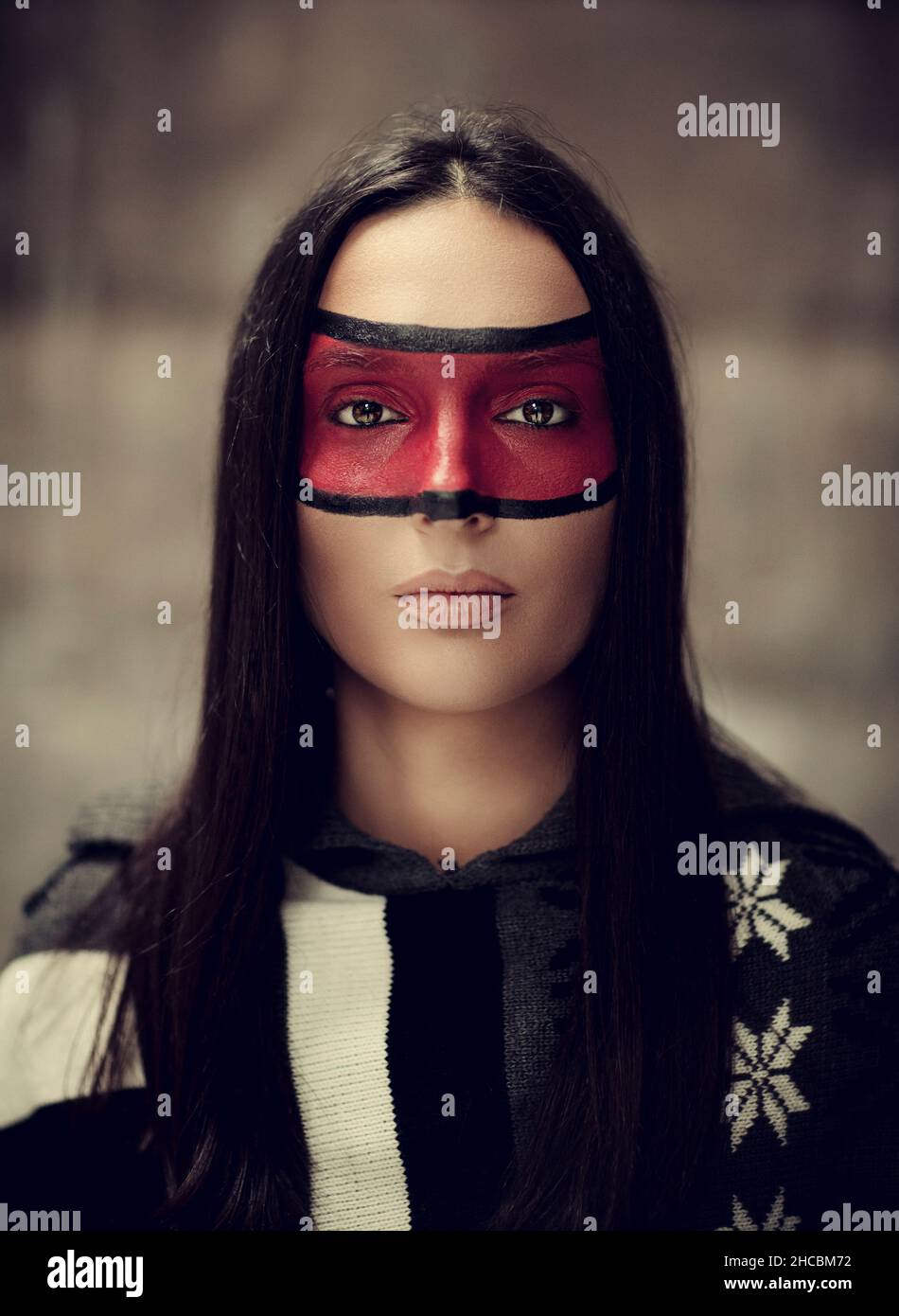 Donna seria con vernice rossa sul viso Foto Stock
