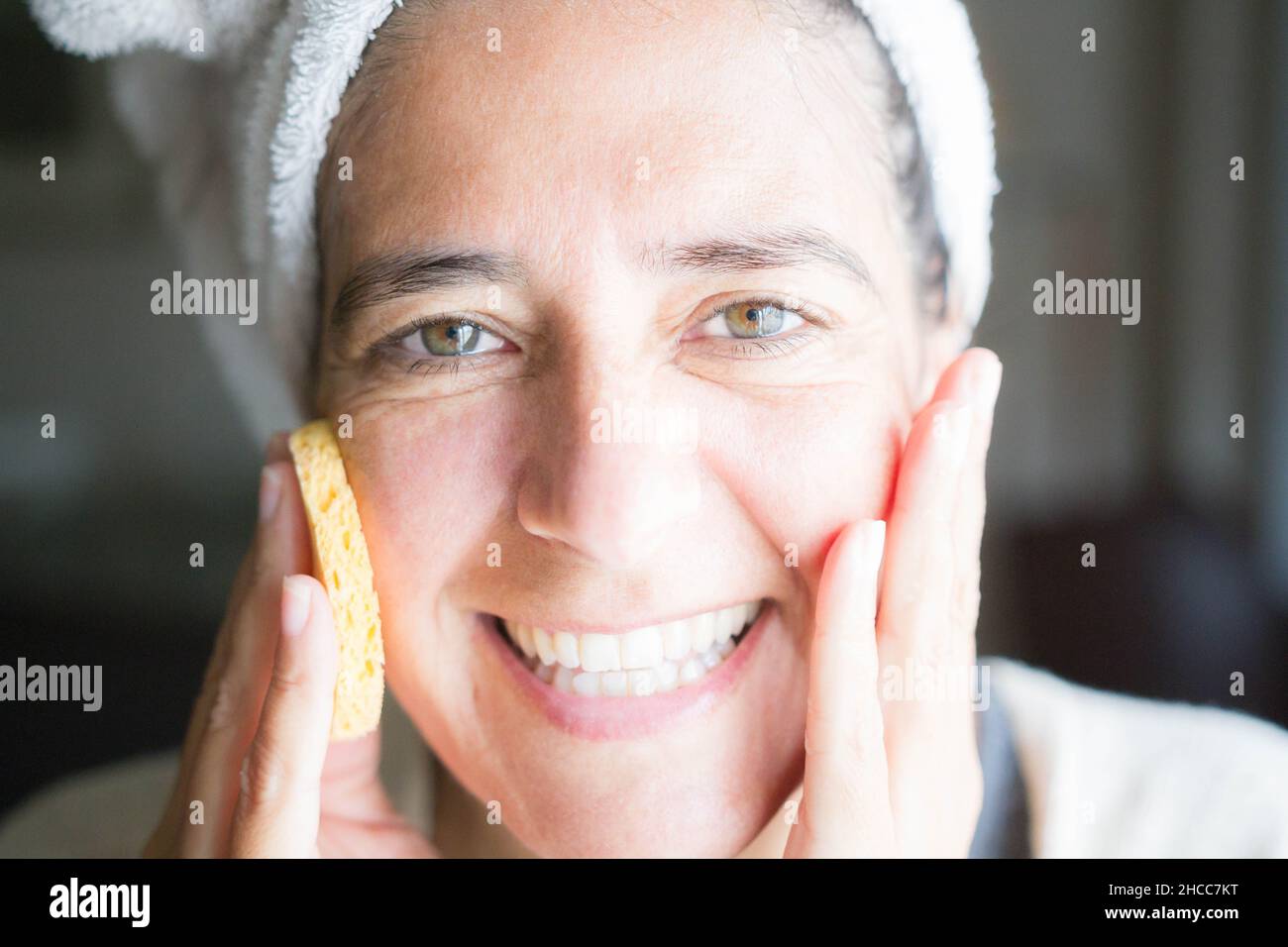 Cura del viso e del corpo con creme. Felice donna di mezza età Foto Stock