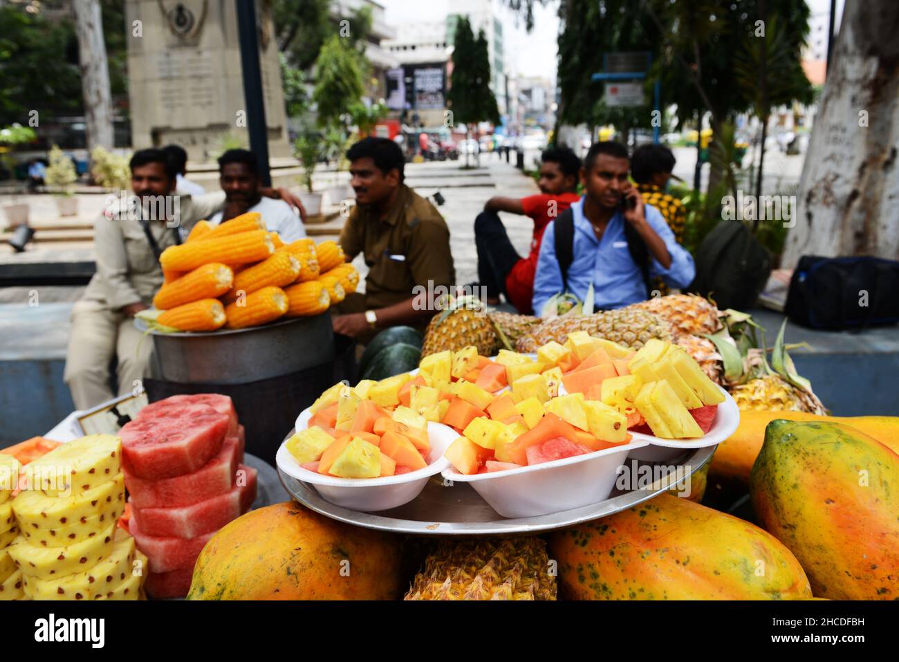 Un fornitore di frutta fresca che vende spuntini di frutta a Bangalore, India. Foto Stock