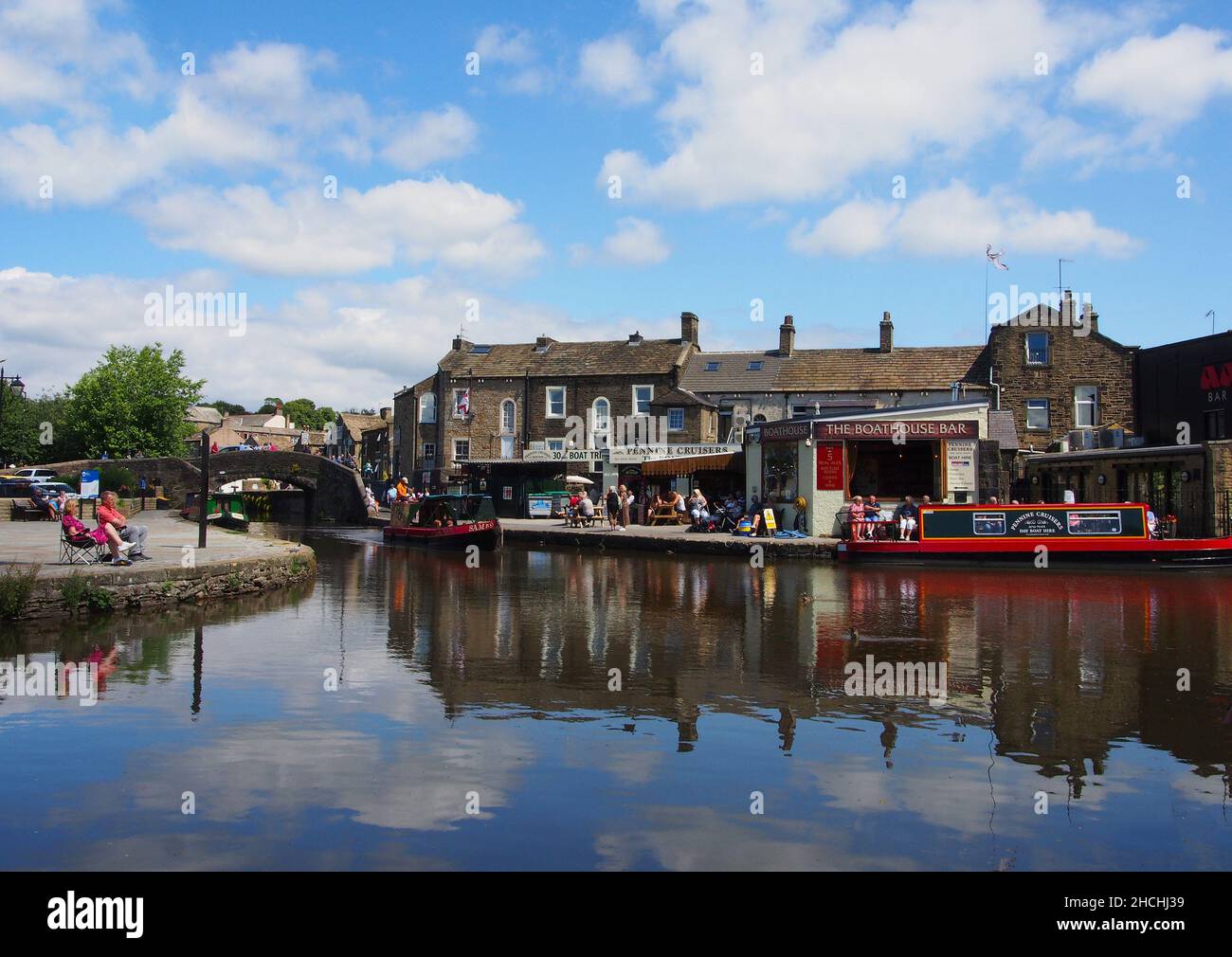 I turisti godono del sole nel bacino del canale sul canale di Leeds e Liverpool a Skipton, North Yorkshire, Inghilterra. Foto Stock