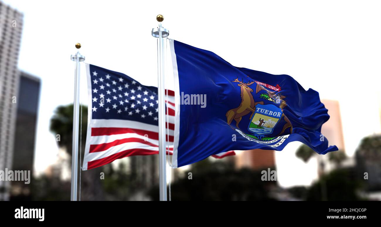 La bandiera dello stato americano del Michigan sventola nel vento con la bandiera americana sfocata sullo sfondo. Il Michigan è stato ammesso all'Unione il Januar Foto Stock