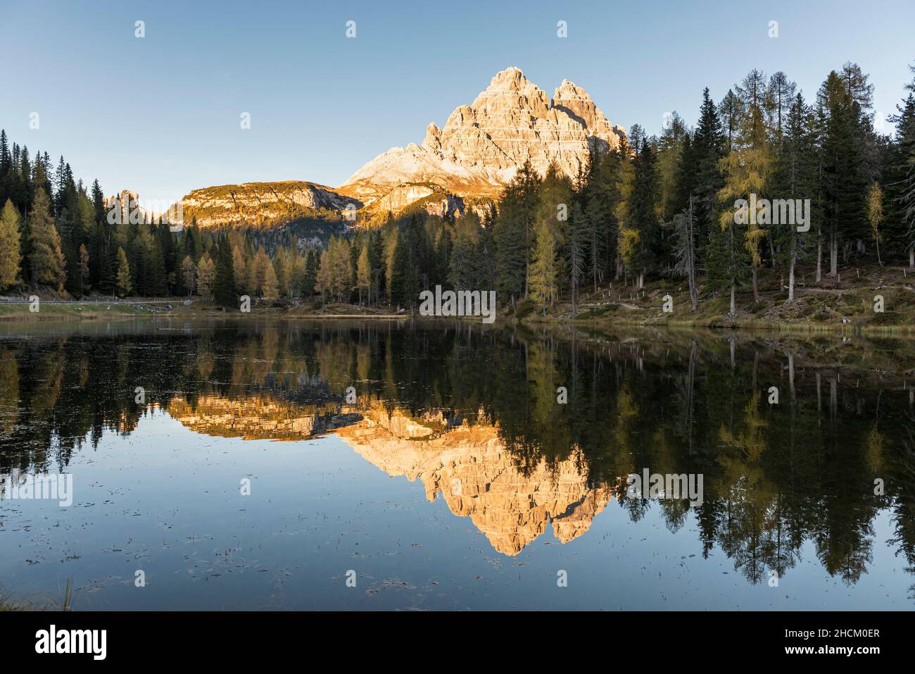 Le tre Cime di Lavaredo nel sole serale che si riflette nelle acque del Lago d'Antorno nelle Dolomiti Sesto autunnali, Italia Foto Stock