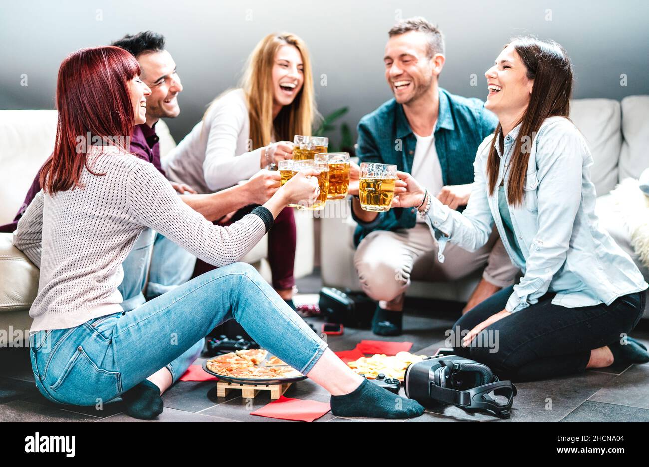 Giovani amici che tostano birra a casa dopo le lezioni universitarie - concetto di amicizia stile di vita con studenti in camera che godono di tempo insieme Foto Stock