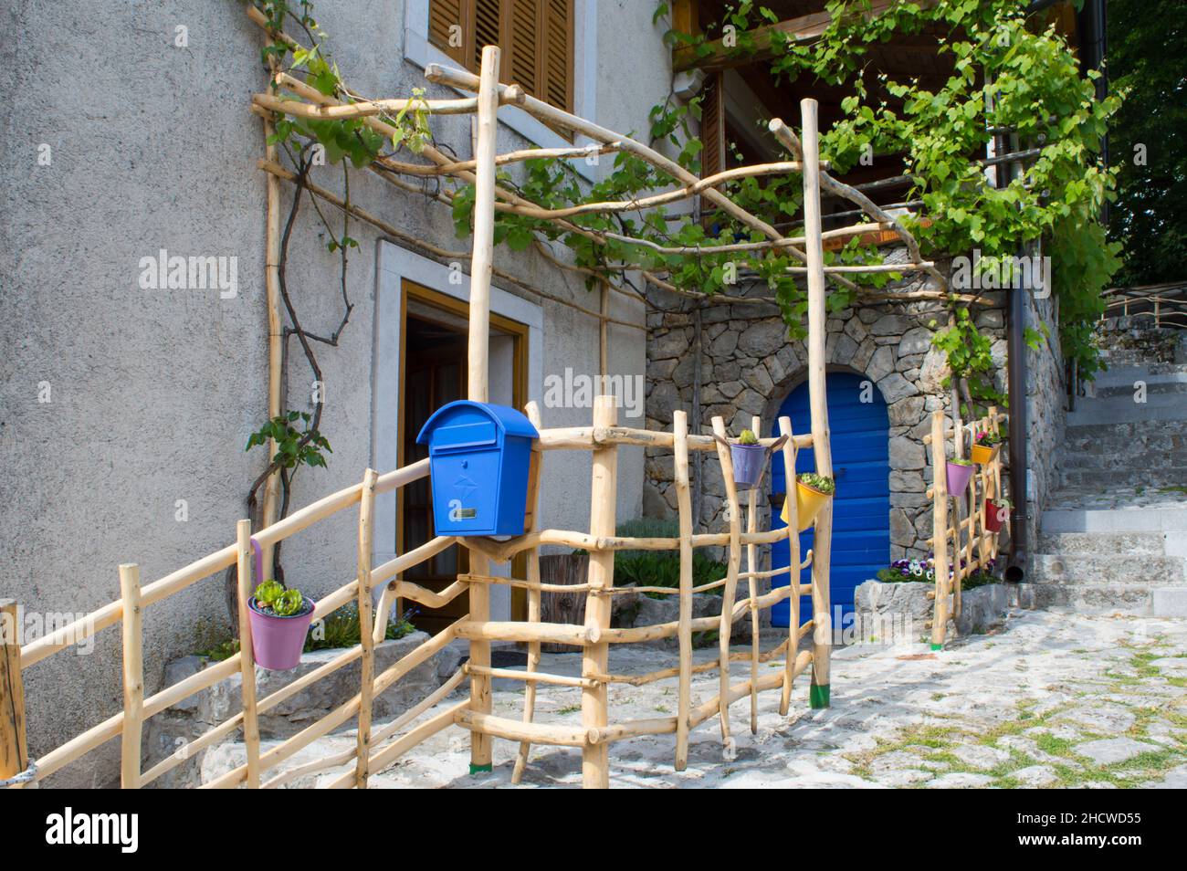 Veprinac, Croazia - Maggio 2017: Casa pittoresca con cortile decorato autenticamente e recinzione in legno fatta in casa con vite Foto Stock