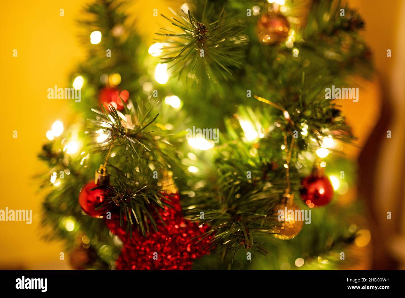 Fuoco selettivo di un albero di Natale con luci e ornamenti Foto Stock
