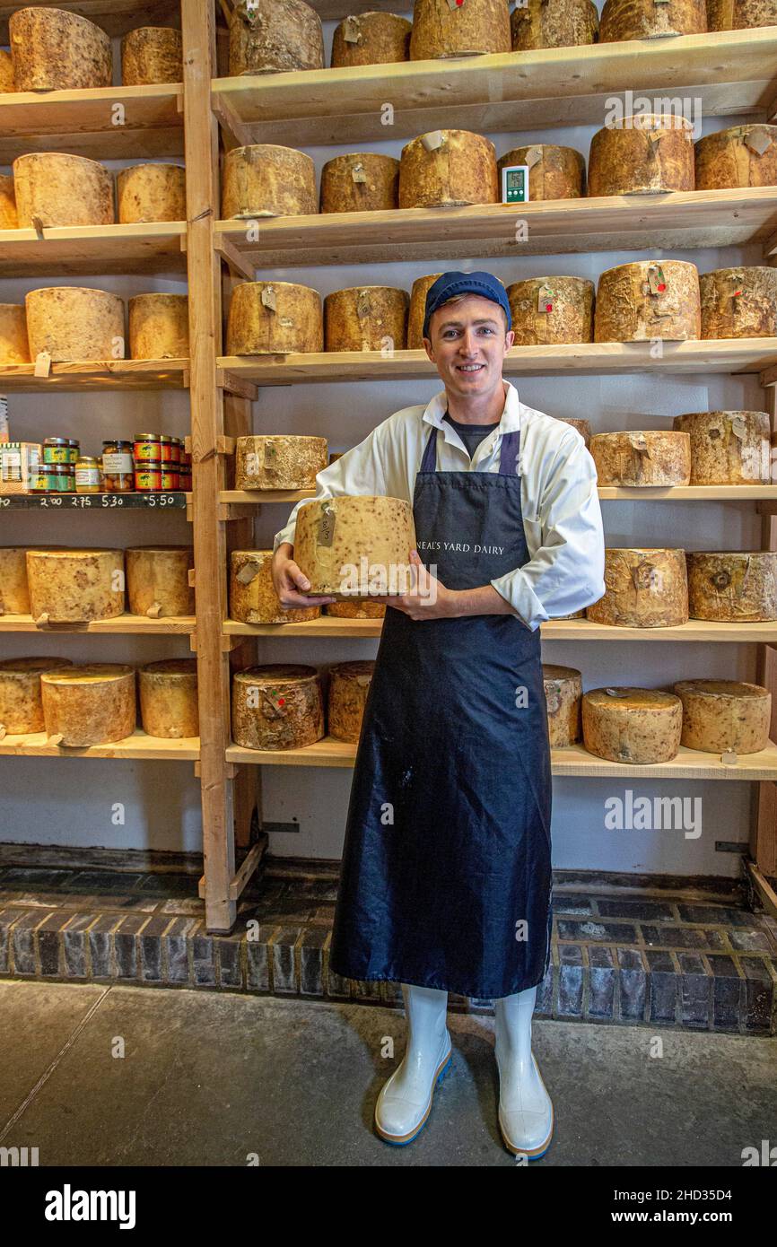 Giovane maschio che vende formaggio al Neal s Yard Dairy al Borough Market a Southwark, Londra, Inghilterra. Foto Stock