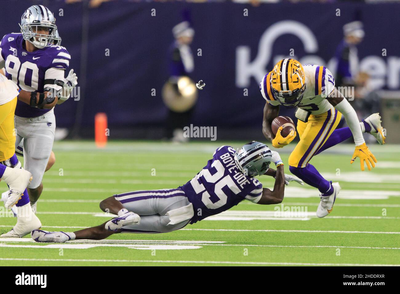 LSU Tigers quarterback Jontre Kirklin (13) evita l'attacco di Kansas state Wildcats difesa indietro Ekow Boye-Doe (25) durante il Texas Bowl di TaxAct, Foto Stock