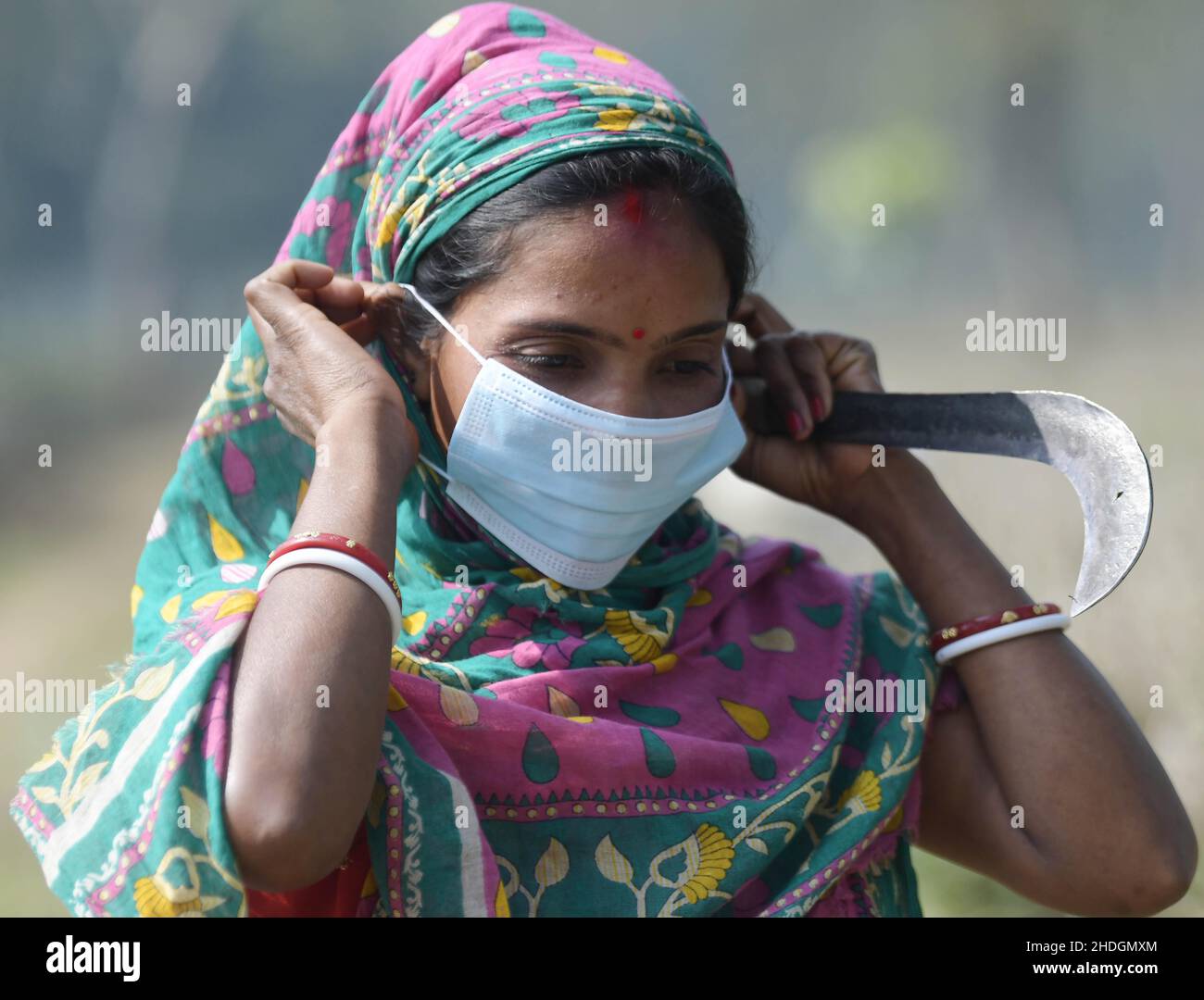 (220106) -- AGARTALA, 6 gennaio 2022 (Xinhua) -- un lavoratore del giardino del tè mette su una maschera in Agartala, la capitale dello stato nord-orientale dell'India di Tripura, 6 gennaio 2022. (Str/Xinhua) Foto Stock