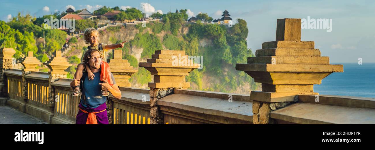 Papà e figlio i viaggiatori in Pura Luhur Uluwatu temple, Bali, Indonesia. Un paesaggio fantastico - scogliera con il blu del cielo e del mare. Viaggiare con bambini concept Foto Stock