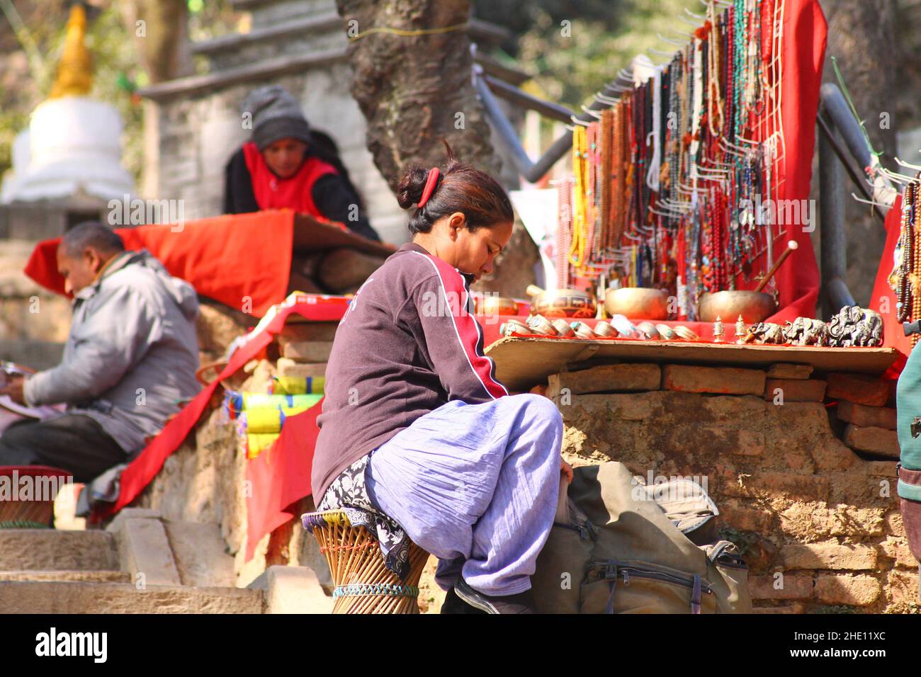 Adoratore femminile al di fuori del Tempio di Swayambunath a Kathmandu, Nepal Foto Stock