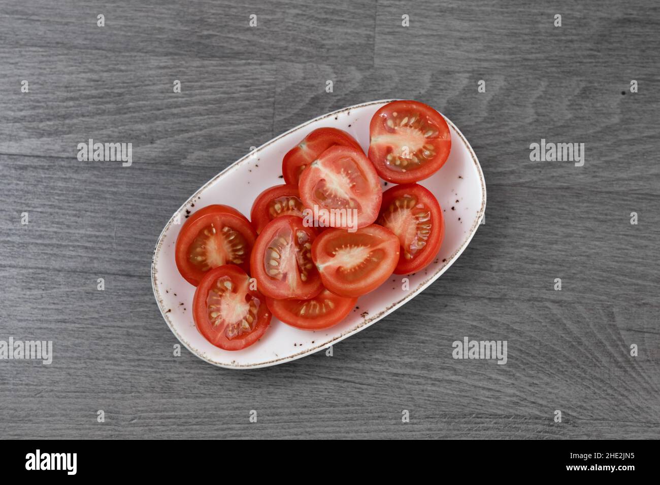 pomodori a fette su tavola di legno Foto Stock