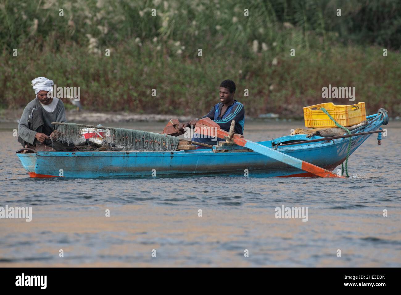 Gli uomini baiting ganci e rete da pesca in una piccola barca nel lago Nasser, parte del fiume Nilo in Egitto. Foto Stock