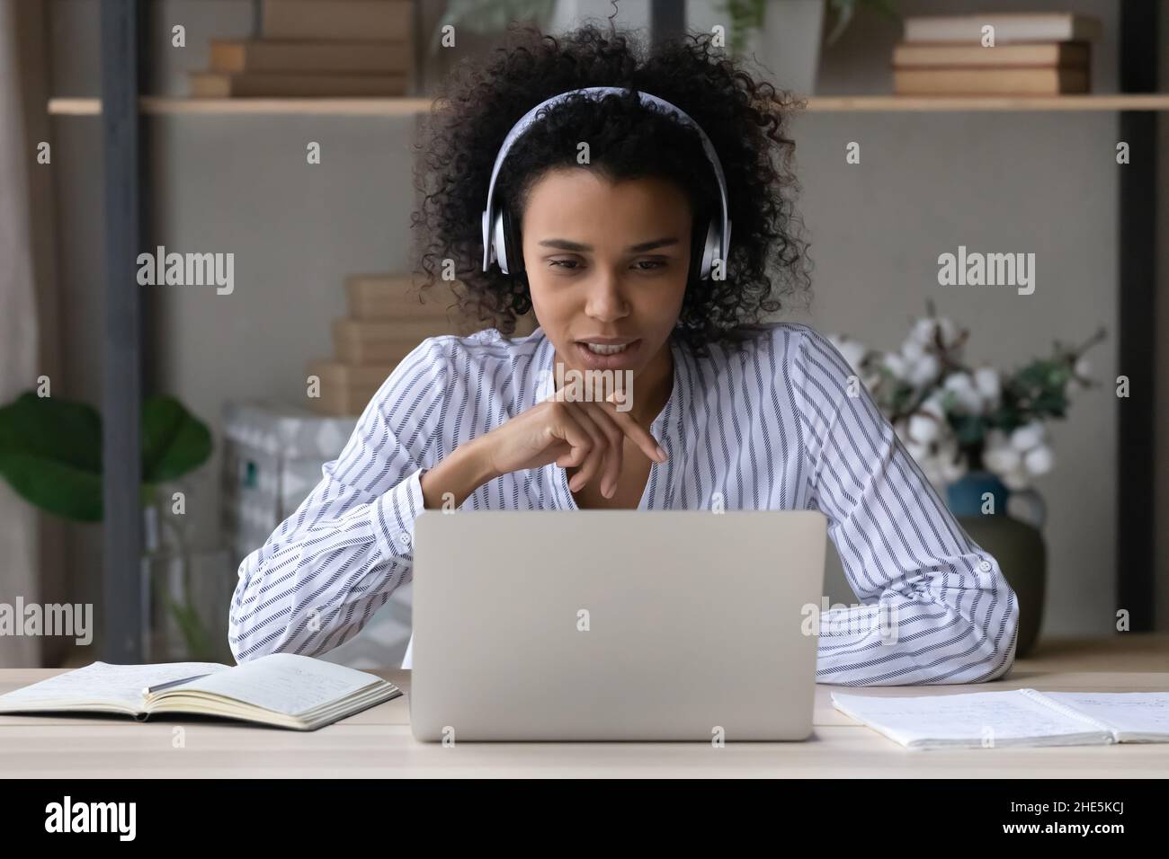 Giovane afroamericana che tiene una videochiamata incontro. Foto Stock