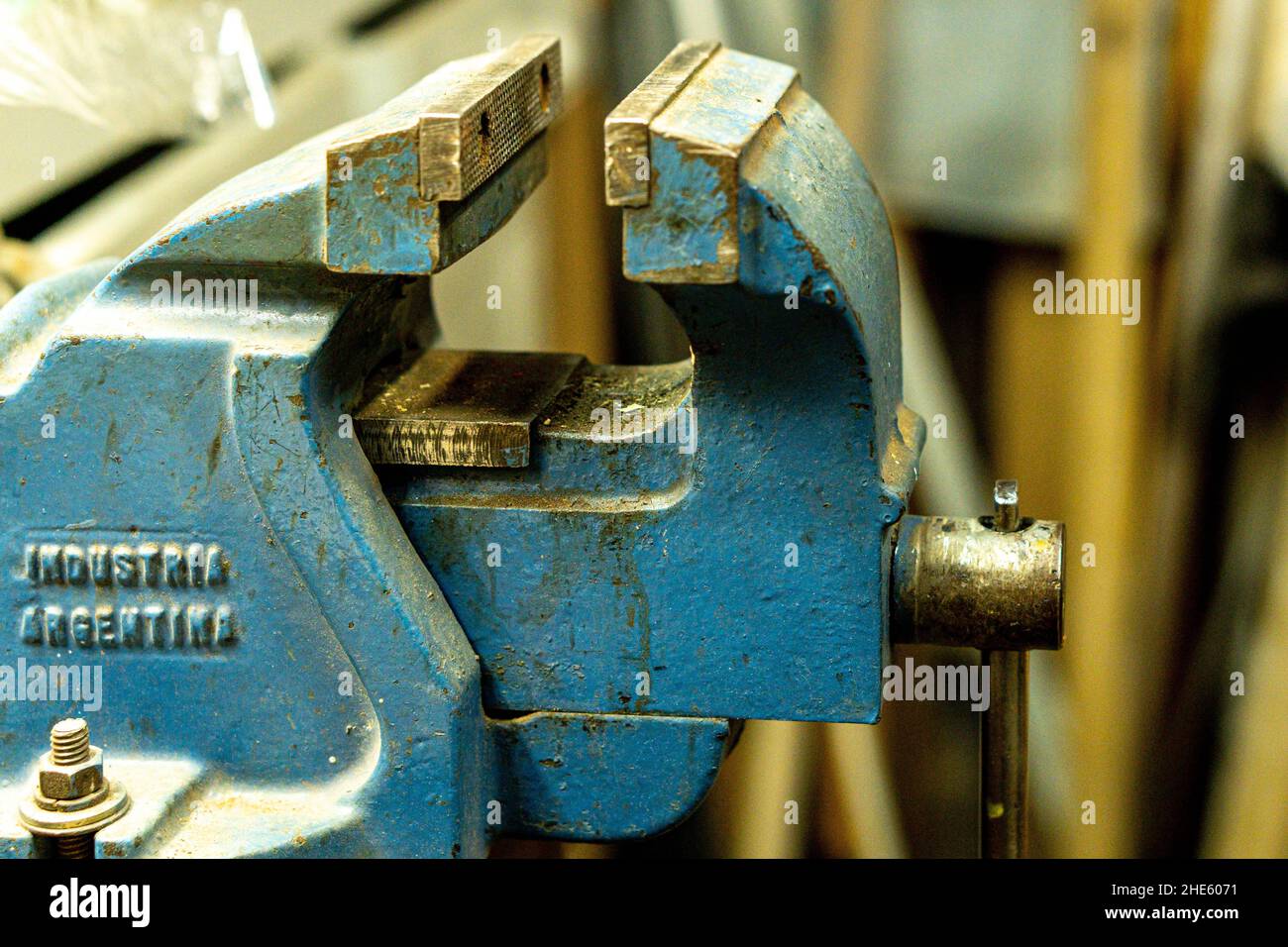 Messa a fuoco selettiva di una vecchia morsa da banco con intemperie e grungy blu Foto Stock