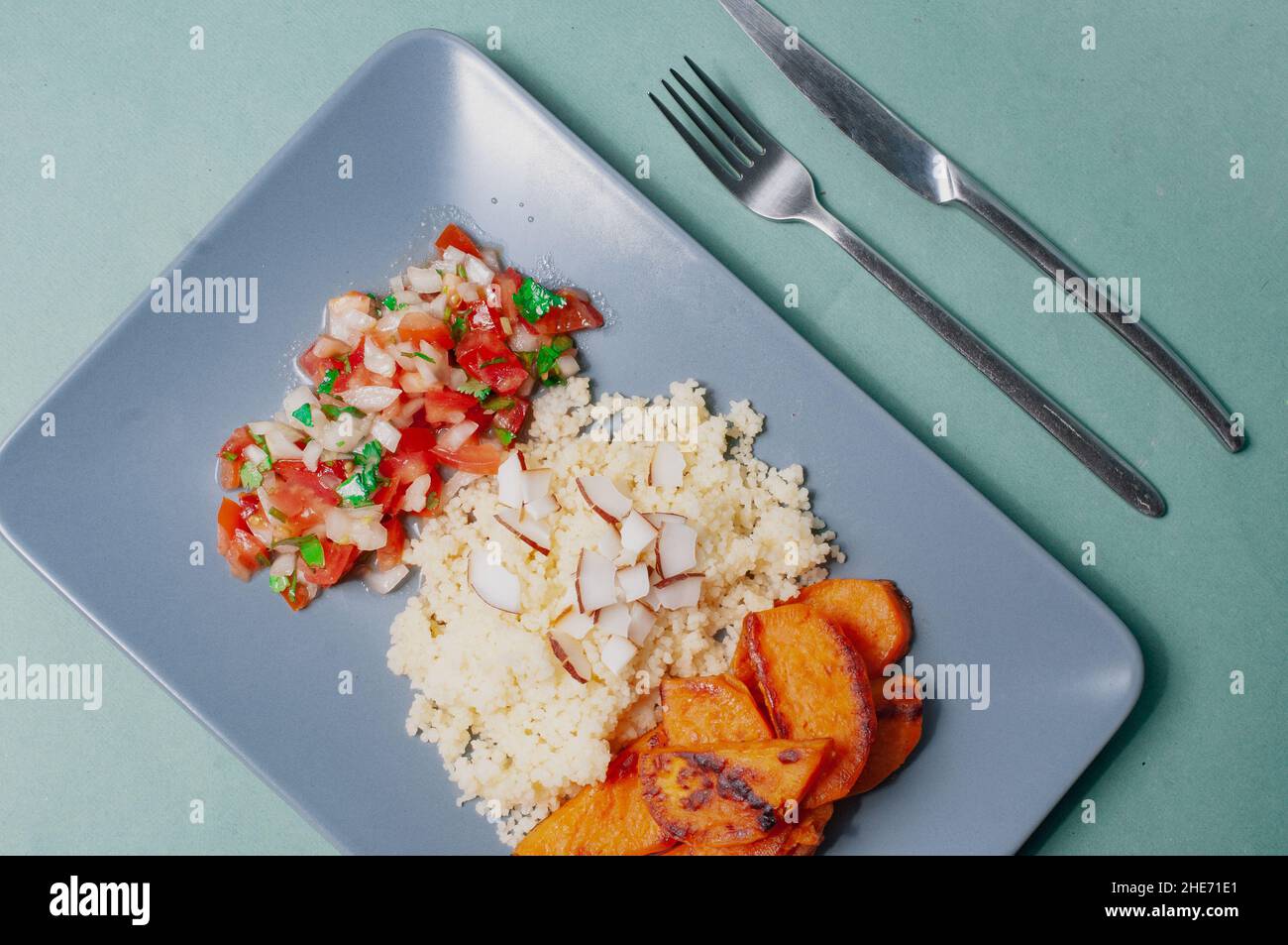 Delizioso cibo minimalista sfondo sudamericano piatto a base di piante patate dolci con cuscus e salsa pivre cilena Foto Stock