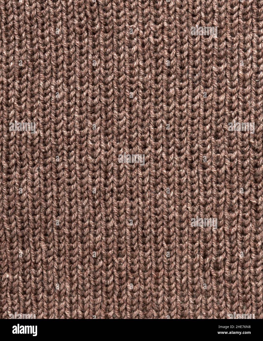 Modello di Unione. Primo piano di tessuto di lana lavorato a maglia. Il motivo marrone si unisce come sfondo. Foto Stock