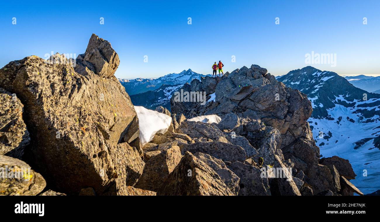 Coppia escursionistica si erge sulla cima e guarda verso la montagna più alta dell'Austria, Grossglockner, Tirolo, Austria, Europa Foto Stock