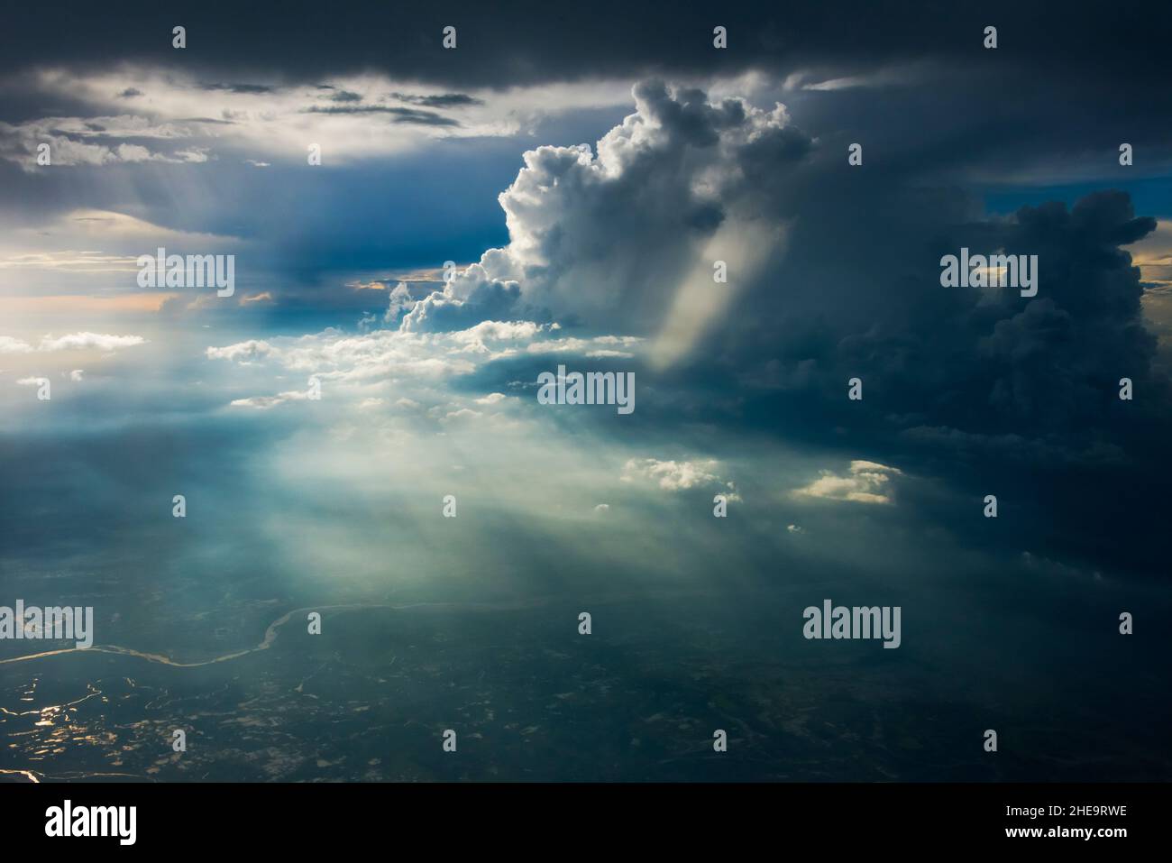 La luce del sole che si infrangono attraverso le nuvole che brillano sulla terra sottostante, l'India Foto Stock