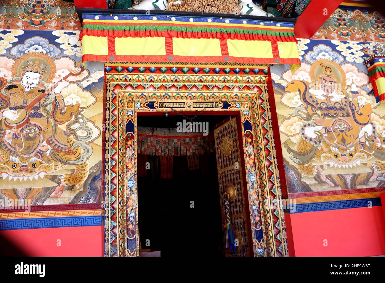 Design colorato su una parete di un monastero a Tawang Arunachal Prodesh, India, opera d'arte di una porta di un monastero, cultura buddista Foto Stock