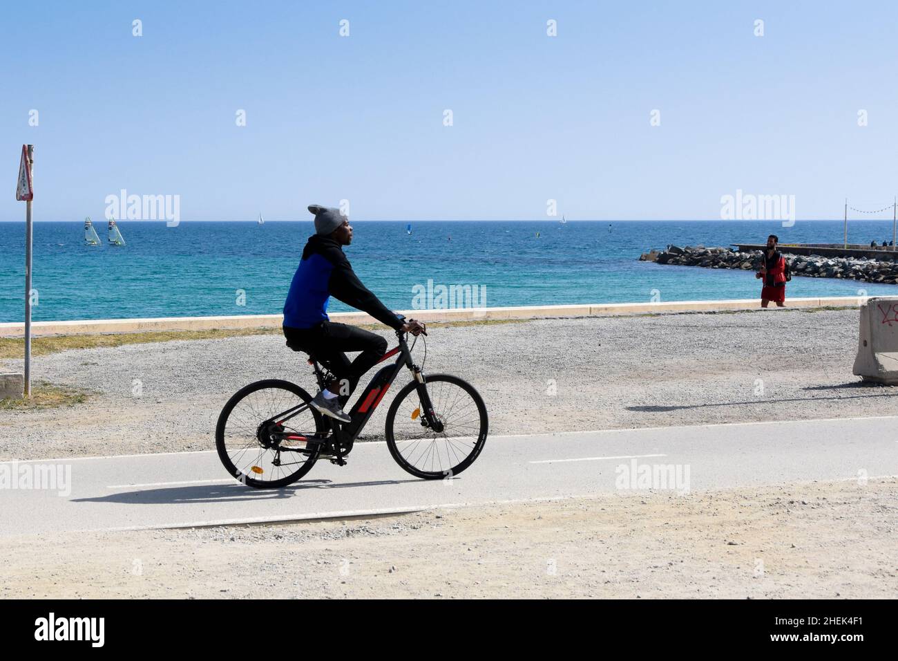 Uomo in bicicletta vicino al mare. Foto Stock